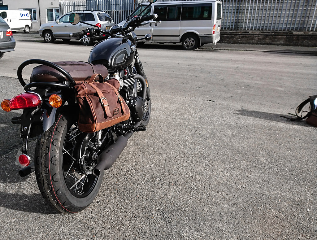 Bonneville T120 black fitted with brown saddlebag.